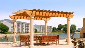 Pergola connected to a landscaped patio and outdoor seating area