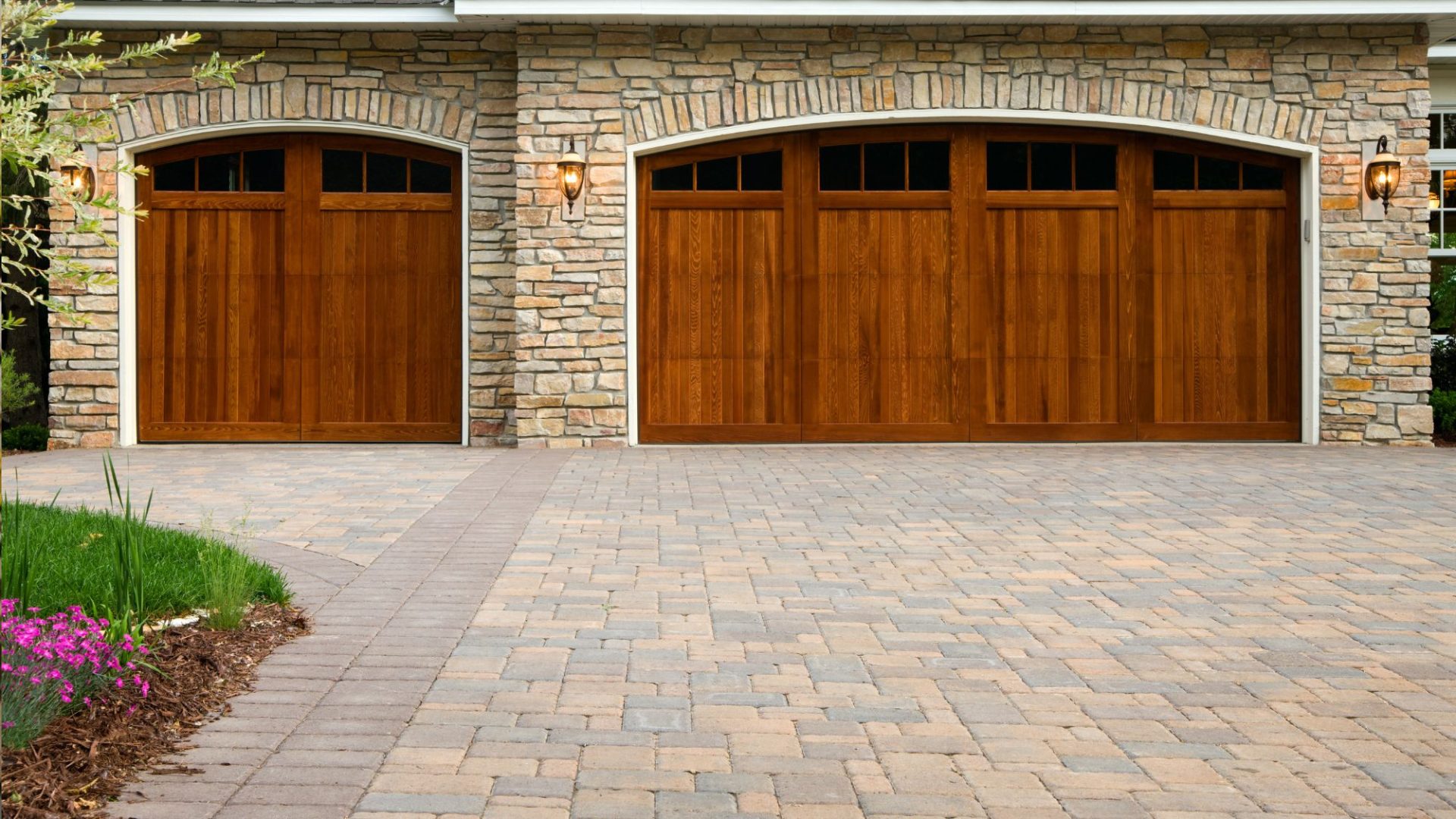 Brick-style paver driveway leading through a residential entrance